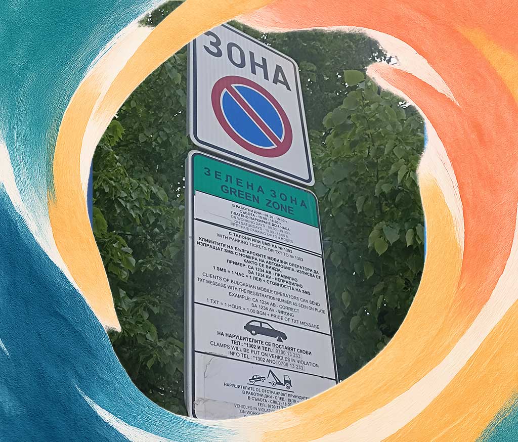 A road sign saying that the area is paid street parking zone and listing short details on how to pay and how long can you stay on the parking spot.