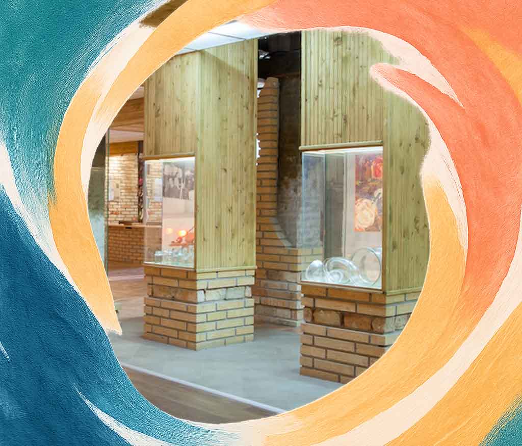 A museum hall inside the Glass Museum displaying colourful handcrafted artworks, a cultural highlight on a day trip from Varna.